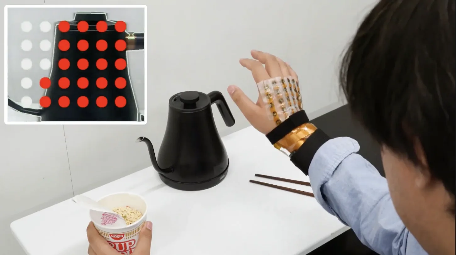 Seeing with the Hands - Hand-mounted electrotactile display for sensory substitution