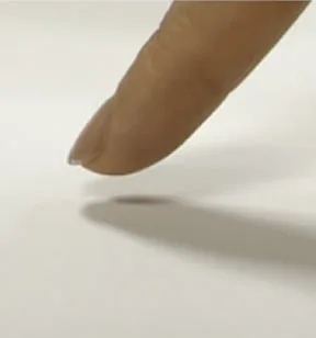 A fingertip hovering just above a surface, illustrating tapping.
